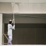 Thai man painting white color on building at construction site in Yala southern provinces of Thailand